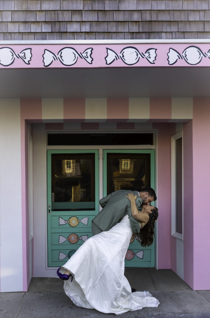 a dip and a kiss in front of the candy store