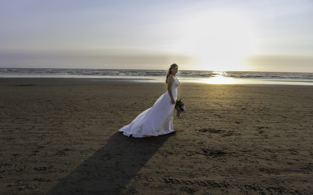 bridal portrait standing in front of ocean