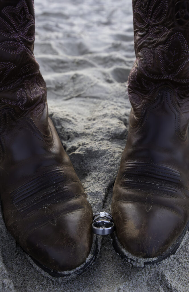 rings highlighted between bride's cowboy boots she was wearing