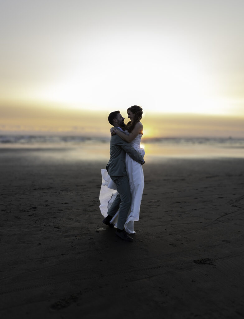 artistic shot of couple dancing in the sunset at the beach 