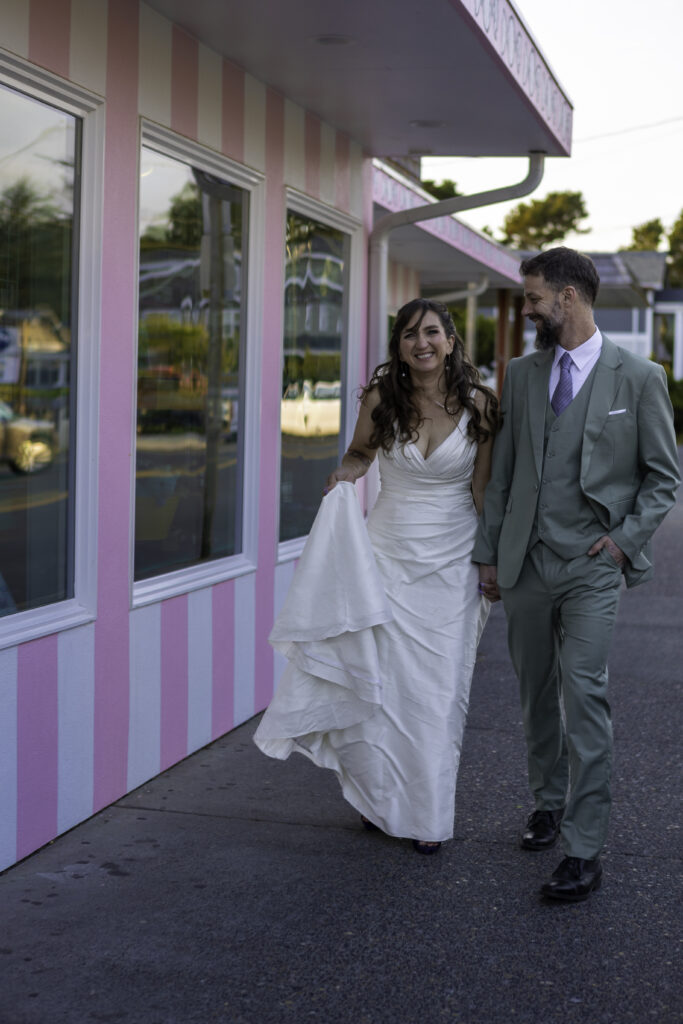 couple walks hand and hand down the charming streets of cannon beach oregon.