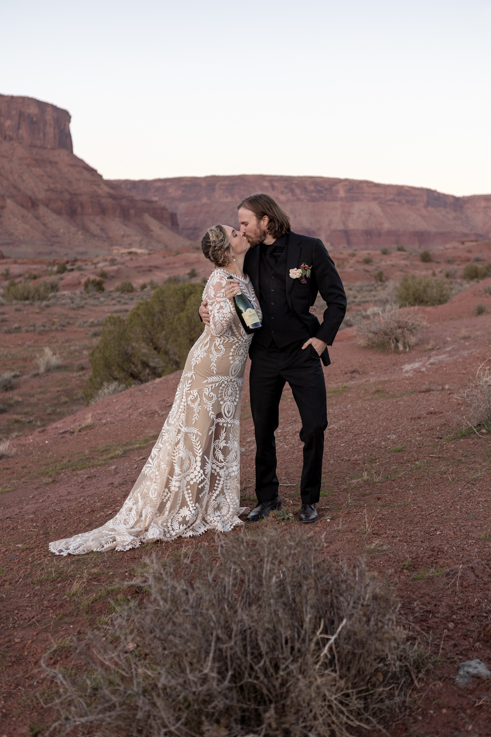 couple posing with champagne bottle