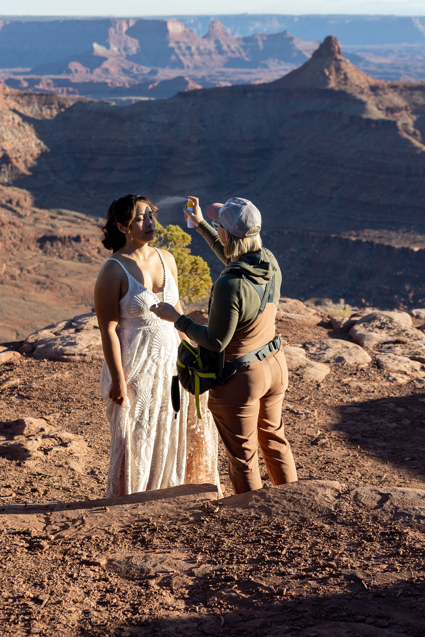 bride gets her makeup touched up out in nature