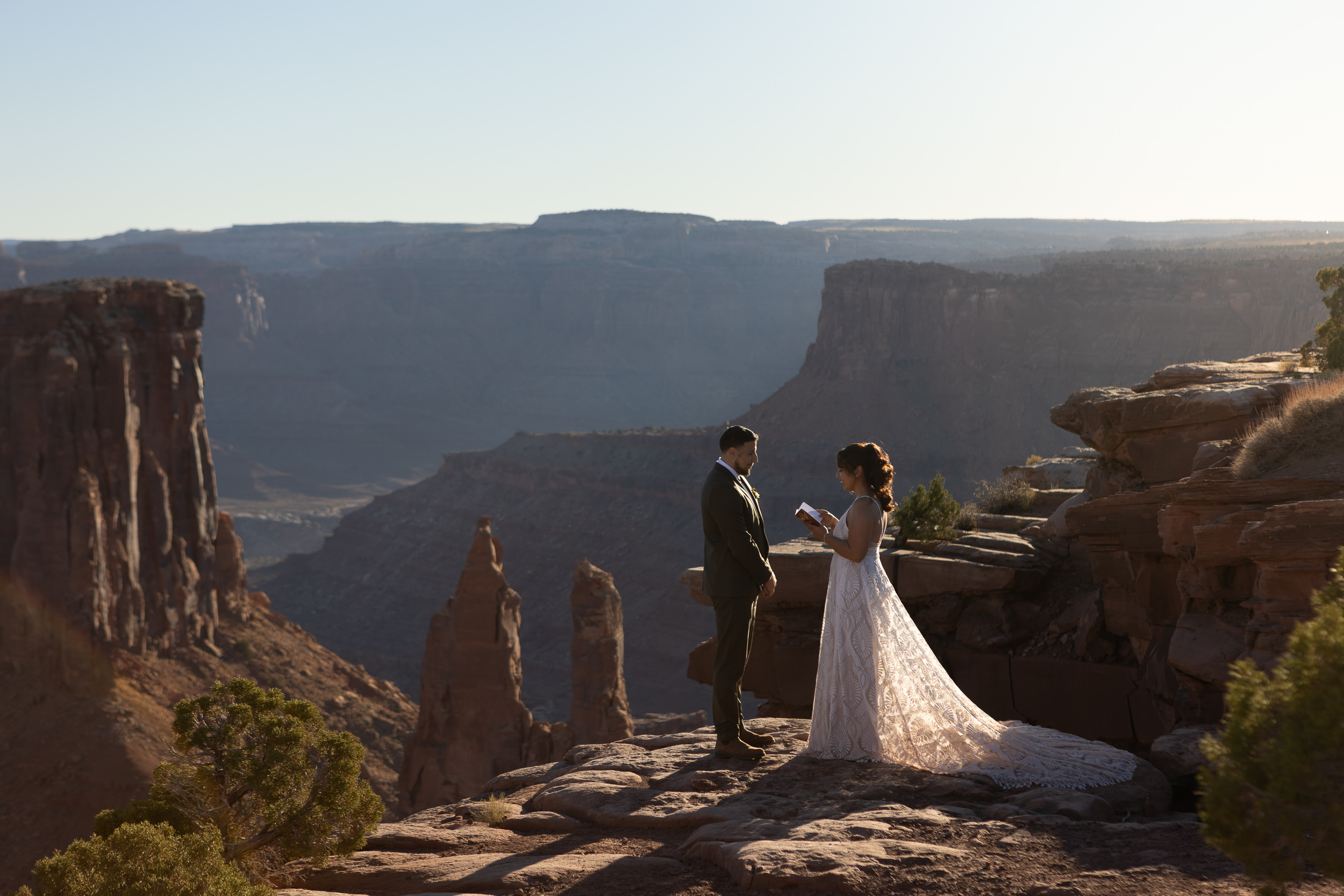 Laura saying her vows on the side of a cliff