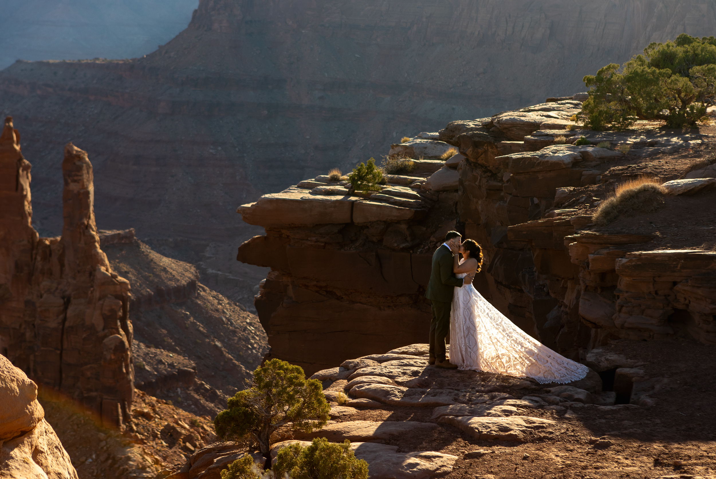 first kiss in the glow of the sun setting across the red rocks