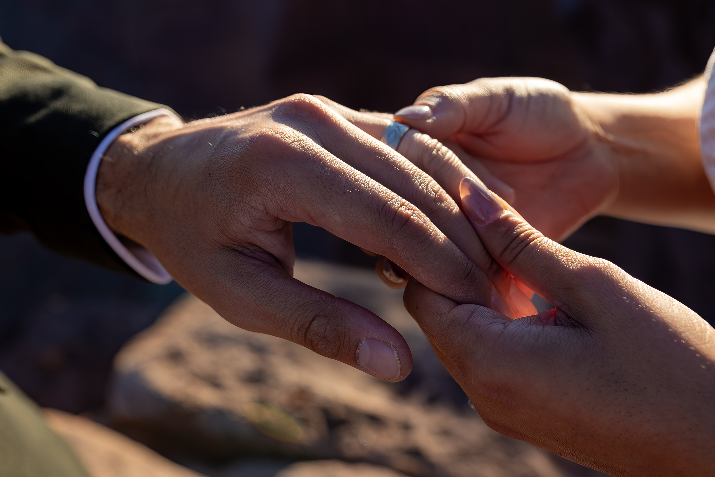 close up of rings being exchanged 