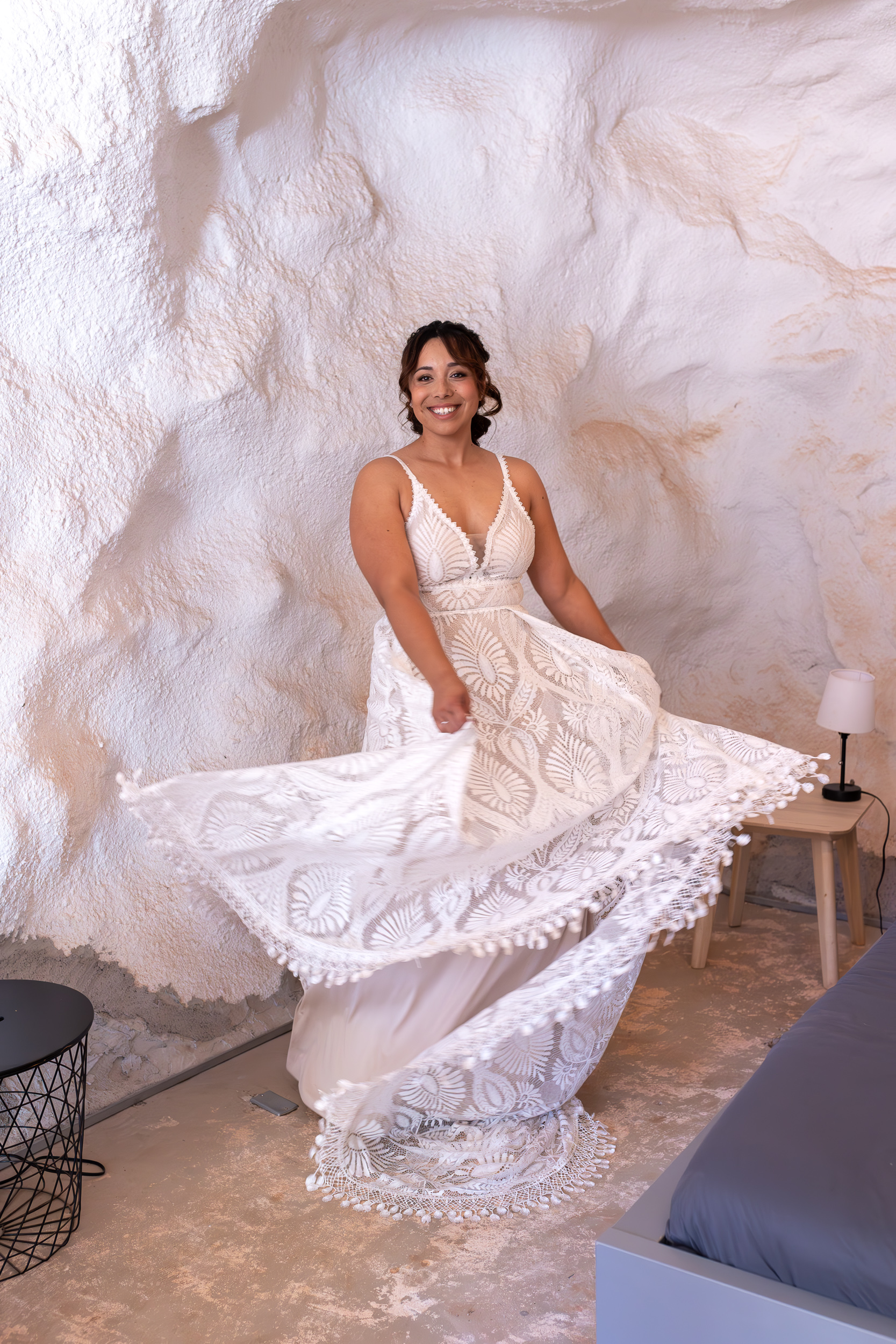 Laura spinning in her wedding dress while getting ready in cave