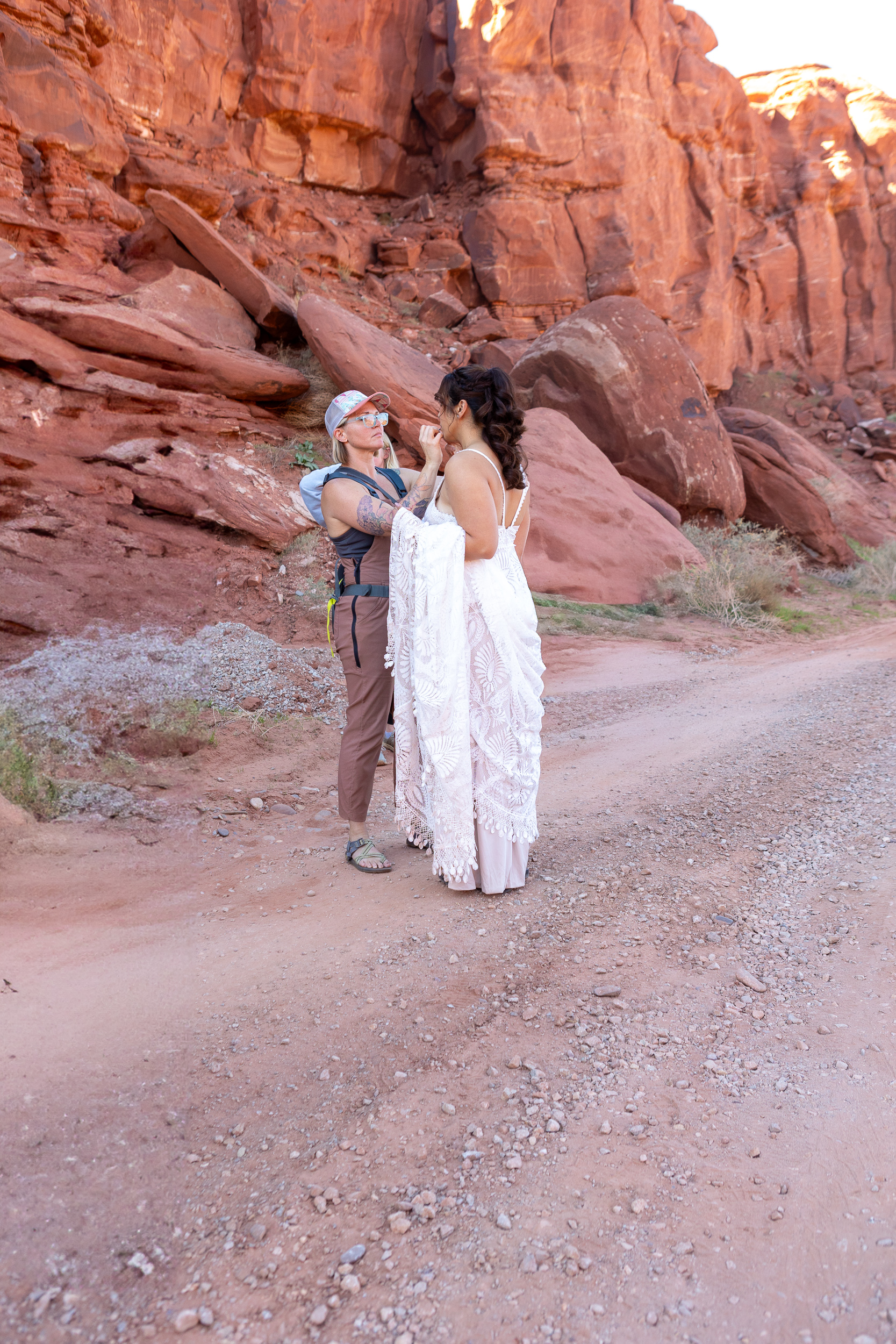 bride gets her makeup touched up out in nature