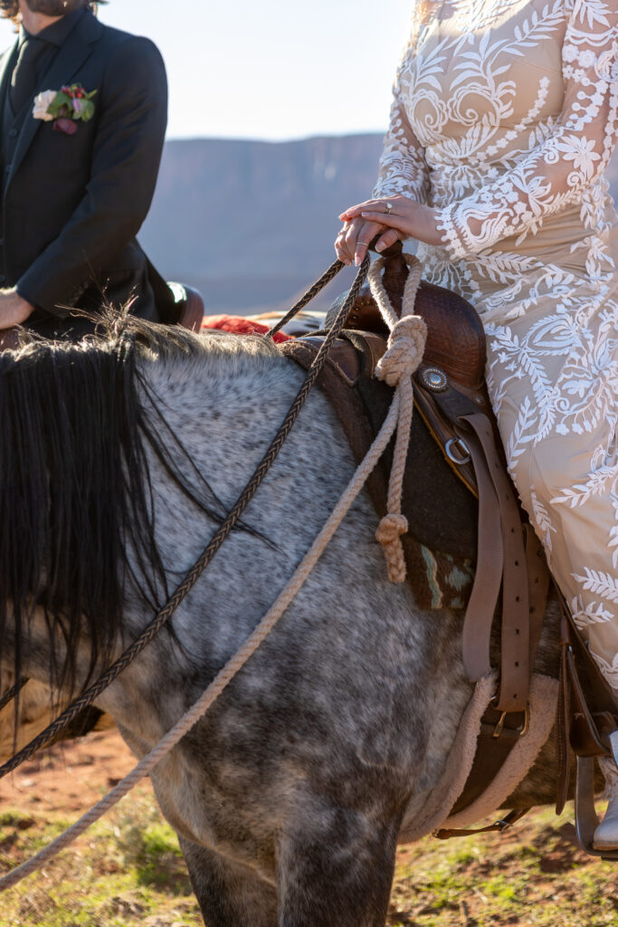 close up of brides hands on horses saddle