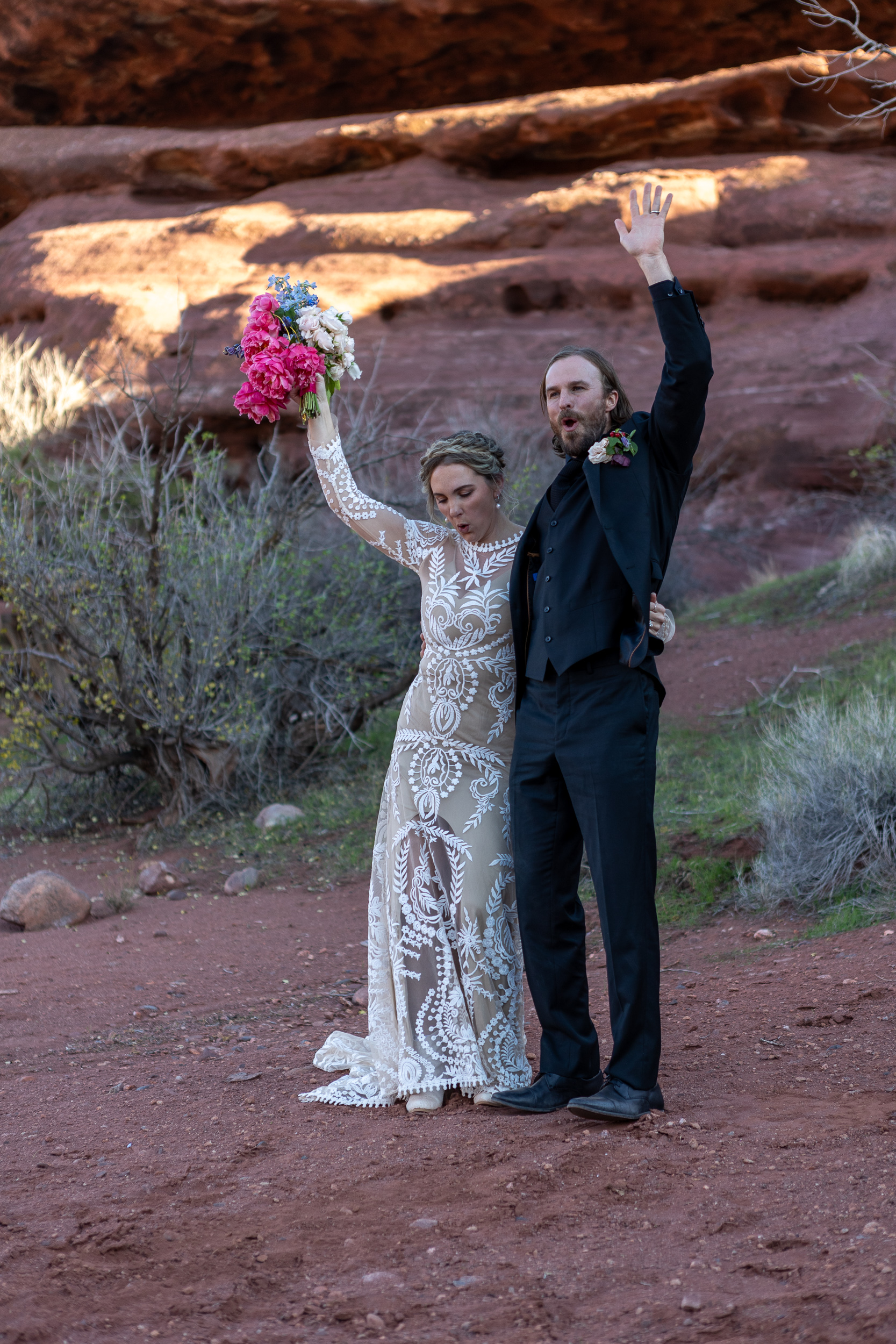 couple celebrates after they said vows with hands in the air they scream wahoo