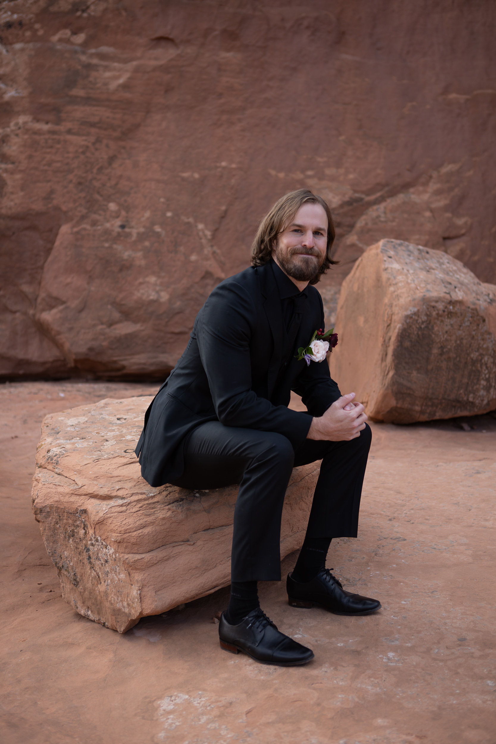elliot sitting on a rock
