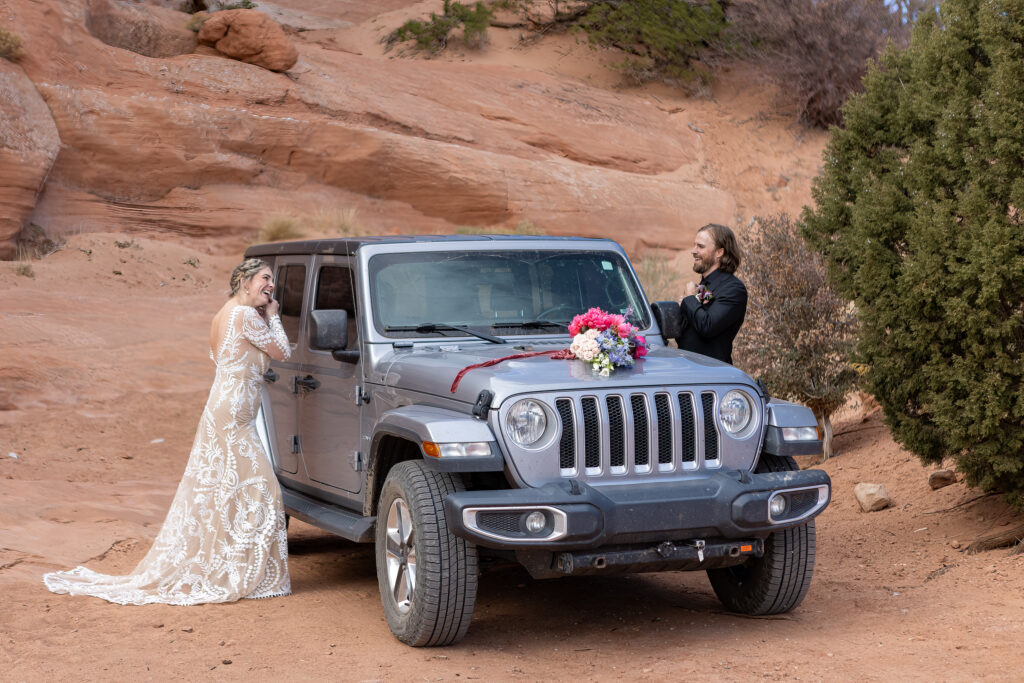 couple getting ready on either side of their jeep