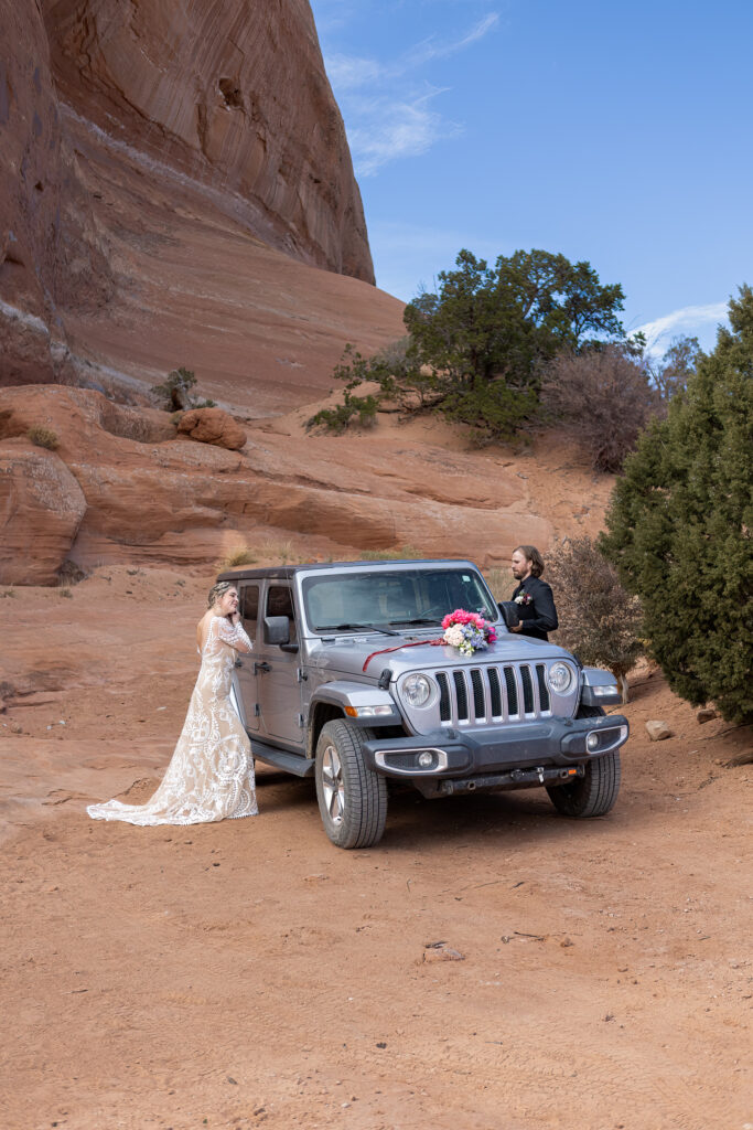 couple getting ready on either side of their jeep