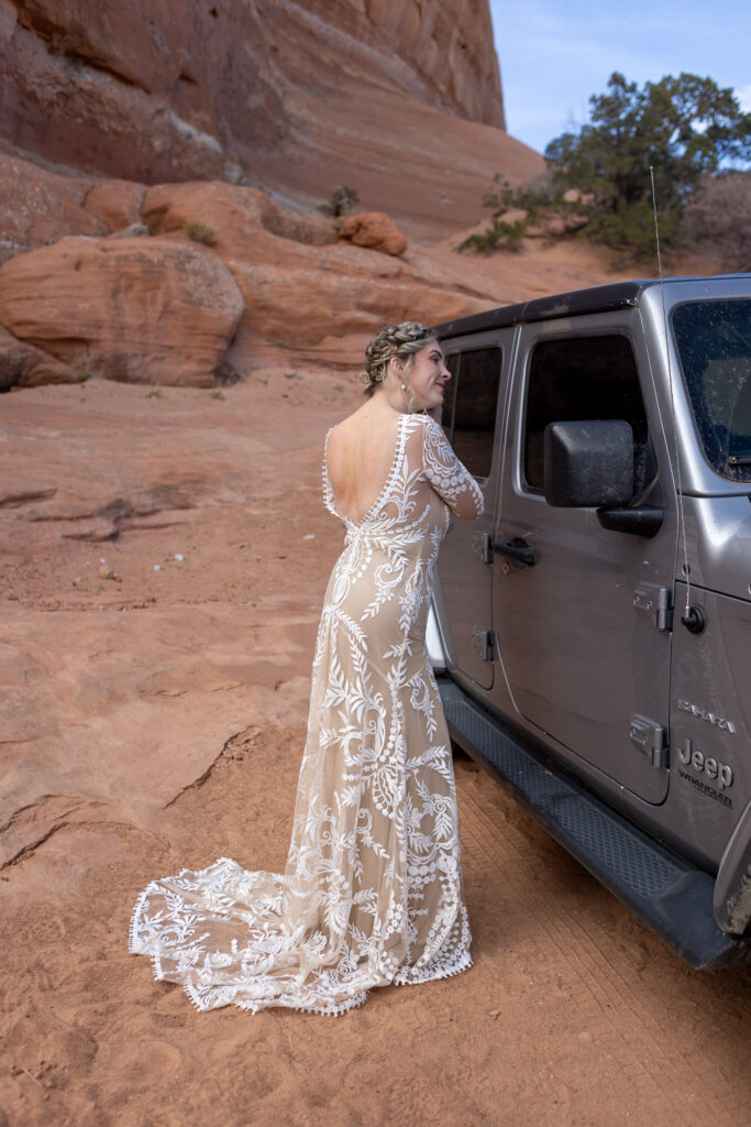 bride adjusting earring in jeep window