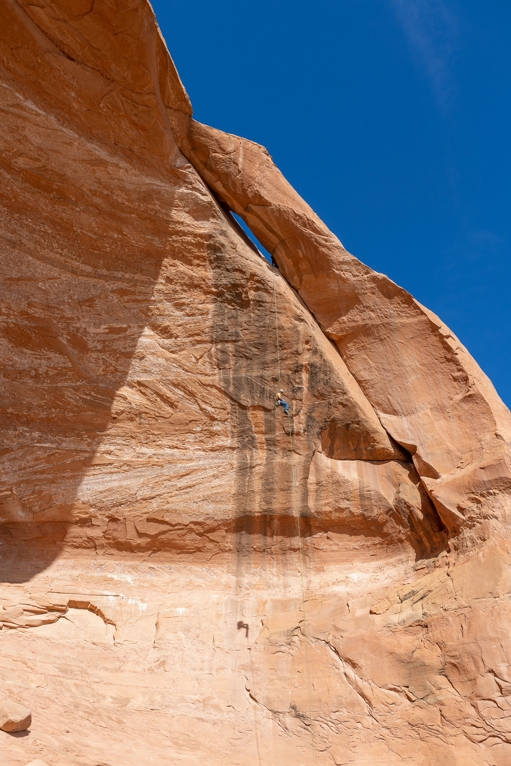 rock climber repelling down cliff