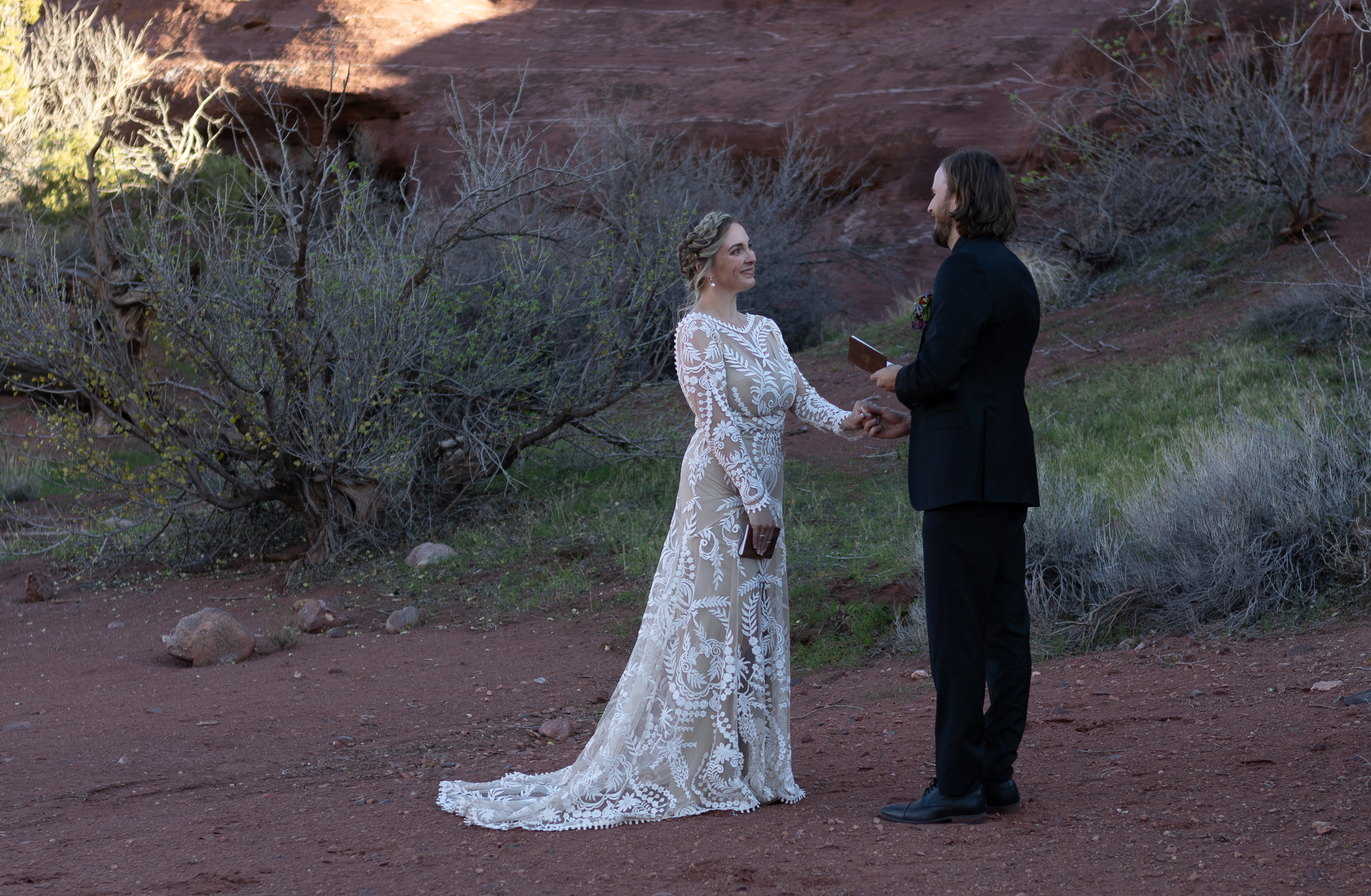 sharing vows while holding hands in moab
