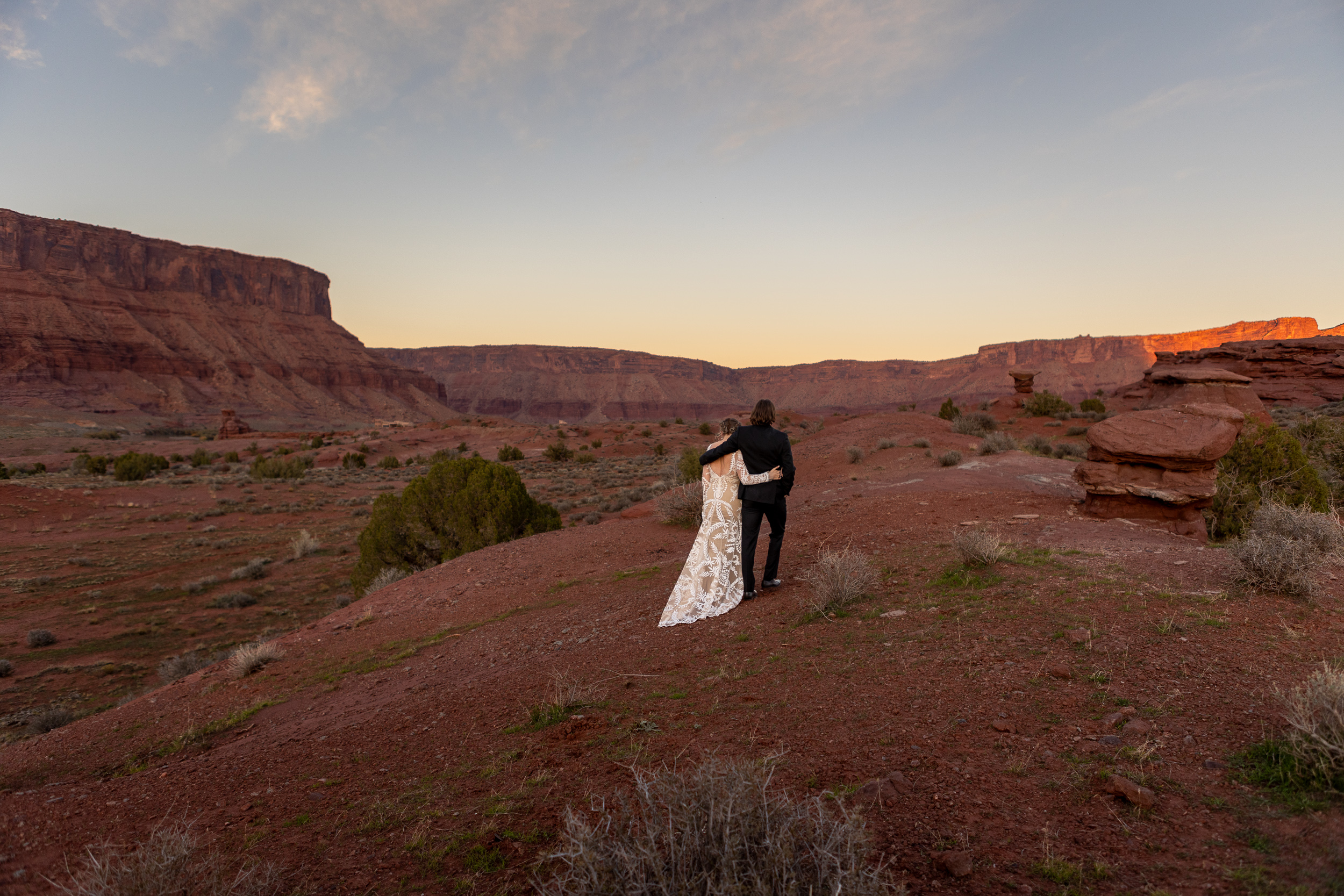 couple walking into the sunset after wedding