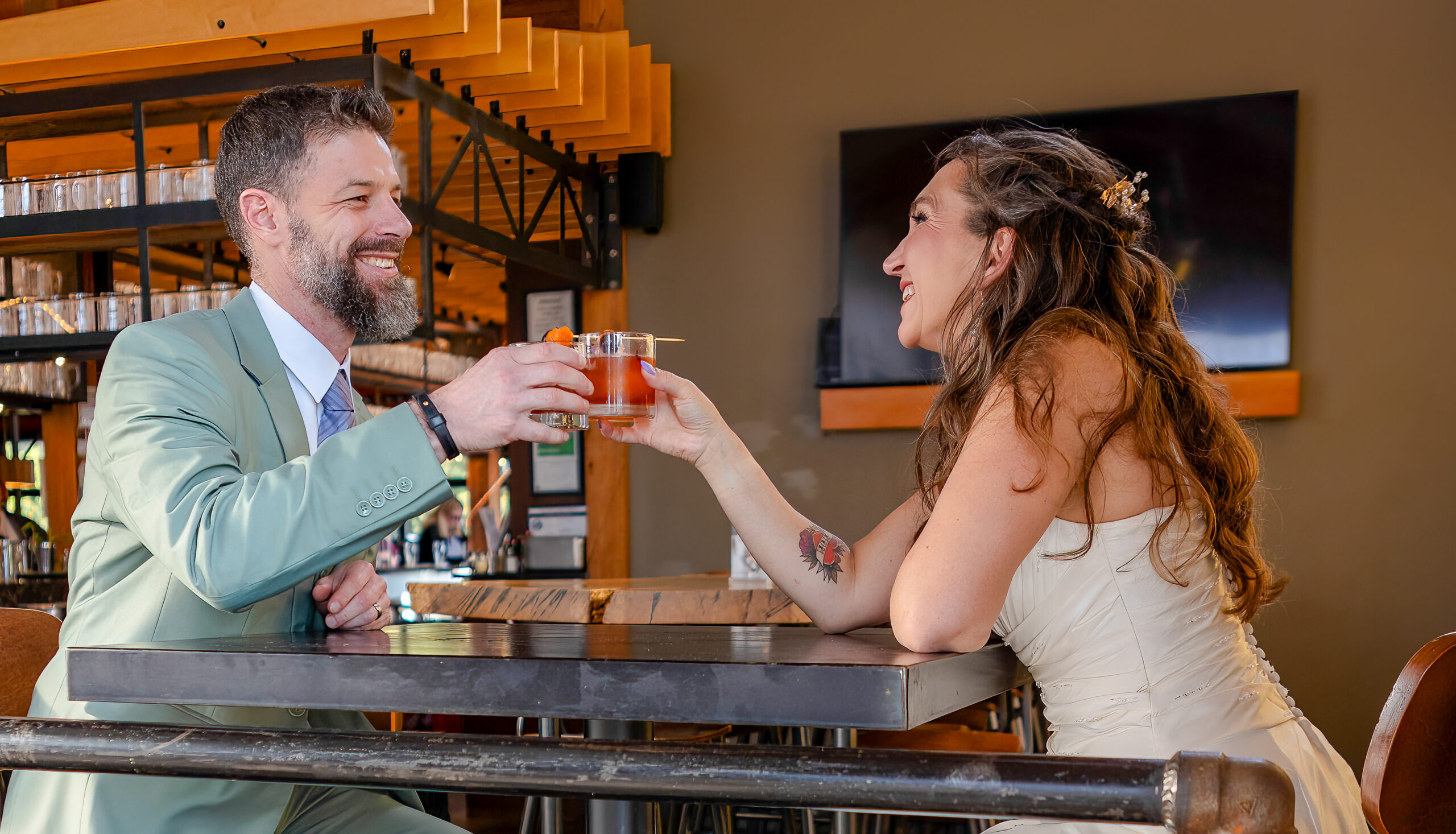 Couple enjoying whiskey after their elopement at Pelican Brewing Company